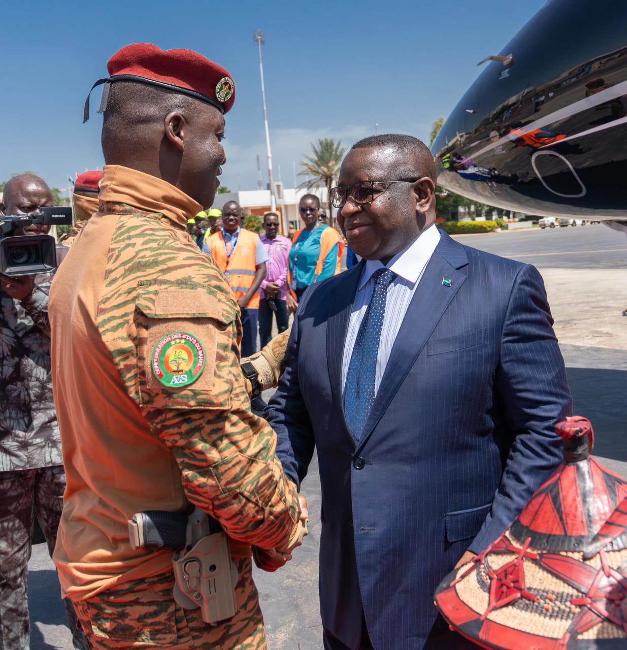 Capt. Ibrahim Traore of Burkina Faso (L) receives Sierra Leone’s Julius Maada Bio (R)